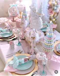 a table set for a baby shower party with pastel colors and pinks, white and blue