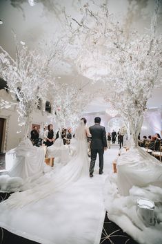 a bride and groom are walking down the aisle