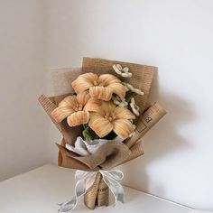 a bouquet of flowers is wrapped in burlap