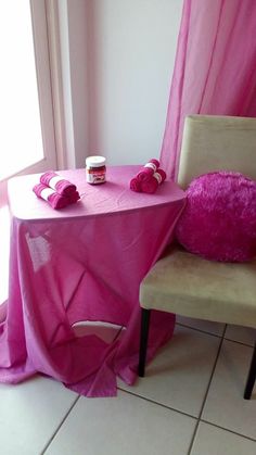 a chair and table covered in pink cloths