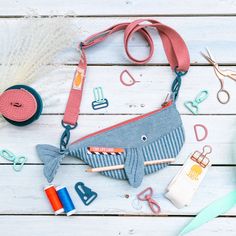 sewing supplies laid out on a white wooden surface