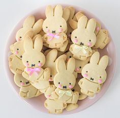 a plate full of cookies decorated to look like bunnies