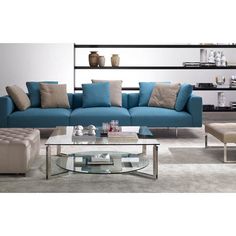 a modern living room with blue couches and coffee table in front of the wall