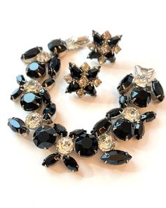 Vintage WEISS Black & Clear Rhinestone Bracelet and Earrings Demi Parure Set Silver Rhodium 1950s Designer Signed Antique Estate Jewelry Offered is this Weiss signed bracelet and earrings set. All stones are still bright and clear.  Started by Albert Weiss in New York, the Weiss Company sold jewelry from about 1942 to 1971. The lovely pieces look as good today as the day they were fashioned. Age: C 1950s Marks: Weiss  Measurements: 7" long and 1 inch wide (bracelet) and the earrings are approximately 7/8" diameter Condition: they are in overall very good condition consistent with age. There is no damage - bracelet clasp and earrings close securely.  Items are vintage or antique and may have slight signs of gentle use as would be expected.  Please let me know if you would like other picture Vintage Jewelry Sets, Wide Bracelet, Pretty Bracelets, Rhinestone Bracelet, Vintage Costume Jewelry, Selling Jewelry, Clear Rhinestones, Glass Jewelry, Vintage Accessories