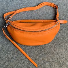 Rebecca Minkoff Bree Mini Belt Bag In Monarch (Orange) Model Photos Are For Size Reference. Please See Photos For Measurements. Orange Color Is Hard To Describe, But It Photographs A Lot Brighter Than Real Life; The Orange Zipper Fabric Is Brighter Than The Duller/Dingier Orange Leather In Person (Photo #8). Floor Photos Were Taken By A Window With Natural Sunlight. Photo #7 Was Taken Outdoors. Photo #8 Was Taken With Indoor Lighting. Used Once Very Briefly For A Baseball Game Years Ago. Selling Bc Haven’t Used It Since. Still Has Tags Inside; Strap Hasn’t Straightened Out Yet. Please Be Aware That The Black Fabric Lining Attracts Lint And Dust. Great For Repping Sports Teams That Ha Mini Belt Bag, Person Photo, Ut Austin, Rebecca Minkoff Bag, Leather Belt Bag, Baseball Game, Natural Sunlight, Orange Leather, Sports Teams