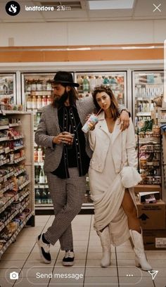 a man and woman are walking through a grocery store with the text send message on their cell phone