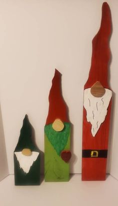 three wooden christmas decorations are sitting on a shelf