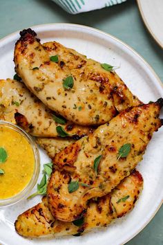 grilled chicken with mustard sauce on a white plate