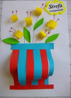 a paper flower vase with yellow flowers in it