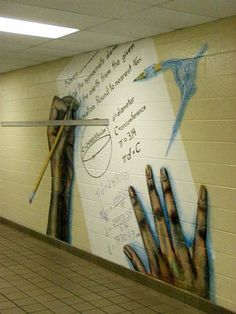 a mural on the side of a wall in a subway station with writing and drawings