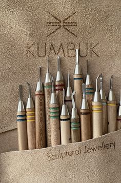 a bunch of different types of woodworking tools in a display case with the words kuabuk on it