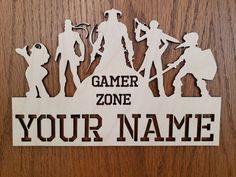 a wooden sign that says gamer zone your name with silhouettes of people holding tennis racquets