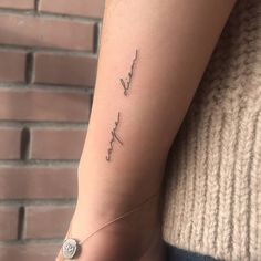 a woman's arm with the word love written in cursive writing on it