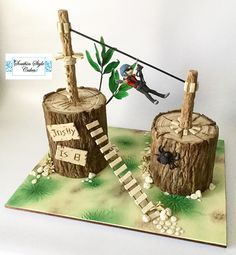 two cakes made to look like logs with people on them