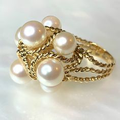 Pearl Ring, Vintage Pearl Ring, Pearl Gold Ring, Pearl Ring For Women, Structural Gold Ring, Pearls Cocktail Ring, Antique Pearl Jewelry An eye catching and stylish never before owned vintage ring featuring 8 genuine white pearls wrapped in braided/ twisted 14k yellow gold. * Ring size: 6 3/4 * Complimentary resizing is available up to 3 sizes larger or smaller than the stated size. Elegant Open Stackable Rings For Jewelry Making, Pearl Ring Vintage, Dainty Earrings Studs, Vintage Pearl Ring, Pearl Gold Ring, Antique Emerald Ring, Pearl Cocktail Ring, Pearl Rings Vintage, Pirate Jewelry