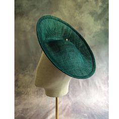 One hat base with a 3.75" tall upturned brim made in teal green stiffened sinamay straw that measures approximately 11" (27.94 cm) in diameter at the top. The base is contoured to fit against the head. The edges of the brim are finished in sinamay. The multi-layer stiffened sinamay straw has a great sturdy weave and provides excellent support for your millinery creations. This is NOT a ready to wear  finished hat and it will not stay on your head unless you add a head band to wear it. This base does have a small sleeve sewn into the crown that will accomodate headbands listed separately in my shop. Add embellishments of your choice. A nice high quality base - I know you'll be pleased! This hat base is listed separately in other colors. Check my listings for available options... Lots of hat Fitted Green Fedora For Kentucky Derby, Spring Fitted Green Fedora, Fitted Green Brimmed Fedora, Green Tailored Brimmed Fedora, Adjustable Green Hat Bands For Kentucky Derby, Adjustable Green Hat Band For Kentucky Derby, Green Adjustable Hat Bands For Kentucky Derby, Green Fitted Hat Band For Kentucky Derby, Fitted Green Hat Bands For Kentucky Derby