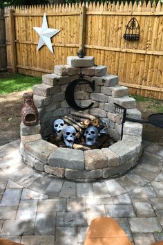 an outdoor fire pit with skulls in it and a star on the top of it