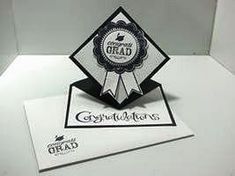 an award is placed on top of a card that reads congratulations with a black and white ribbon