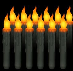 many lit candles are arranged in rows against a black background, with orange and yellow lights