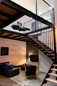 there is a living room with stairs going up to the second floor