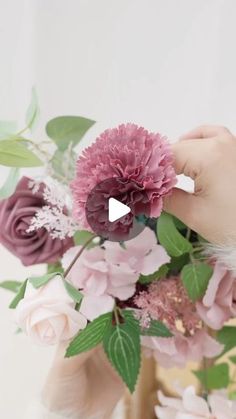 a person is arranging flowers in a vase