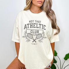 "🎾 Join the Not That Athletic Club Today! Elevate your humor game with a t shirt that serves up laughs and style in equal measure. Whether you're hitting the courts or just hitting the couch, this tee is your VIP pass to the Not That Athletic Club. Let the world know you're here for the fun, not the fitness! ️💖 🎁 The Perfect Gift: Searching for a gift that serves up both style and laughs? Look no further! This t-shirt is not just an outfit; it's a statement. Gift it to that friend who's more likely to score points with puns than on the court. IMPORTANT Mockups are used for demonstration purposes only, and the final product may vary slightly in color & placement. ❤️SIZE & FIT: Comfort Colors Unisex T-shirt True to size with a relaxed fit.  **Size up 1 or 2 if you like an oversized fit. D Vip Pass, Tennis Shirt, Tennis Gifts, Sports Club, Athletic Club, Tennis Club, Tennis Shirts, Tennis Clubs, Athletic Clubs