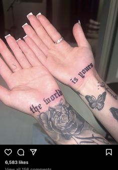 two hands with tattoos on them that say, the world is yours and roses are in each hand