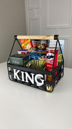 a basket filled with books and snacks sitting on top of a table