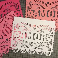 some cut outs are laying on top of each other with the word mom in black and pink