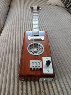 an old ukulele is laying on the bed