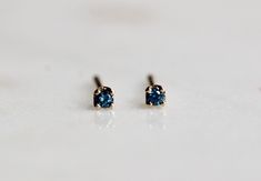 Perfect for multiple piercings, our 14K tiny blue diamond studs are a sweet addition to any outfit! They also make a great bridesmaid gift! - Handcrafted out of 14K gold - Choose between yellow or white gold - Blue diamonds are 1.7mm each - Comes with matching butterfly backs Processing times - Current processing time is 1 - 3 weeks. Each Item is handmade to order with love and care! In Stock Items - Contact Liesel Love with any rush order questions, or to see if we have anything ready made and Tiny Blue Jewelry For Anniversary, Blue Birthstone Earrings For Jewelry Making, Blue Birthstone Earrings For Crafting, Blue Stones Jewelry, Multiple Piercings, Blue Diamonds, Dainty Studs, Tiny Studs, Tiny Earrings