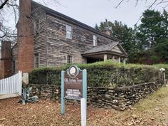 an old house with a sign in front of it