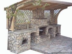 an outdoor stone pizza oven built into the ground