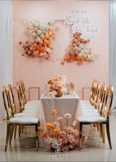 a table with chairs and flowers on it in front of a sign that says happy mother's day