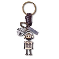 a metal robot keychain with keys attached to it's back and two other items hanging from the front