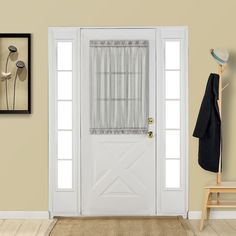 a white front door with curtains and a coat rack