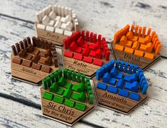 four wooden puzzles with different colors and sizes on top of each other, sitting on a table