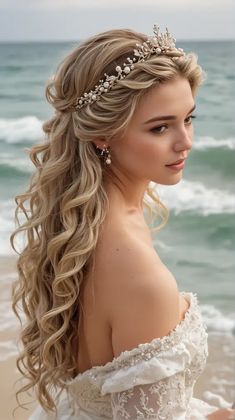 a woman with long blonde hair wearing a tiara on the beach, looking off to the side