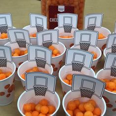 small cups filled with oranges sitting on top of a table