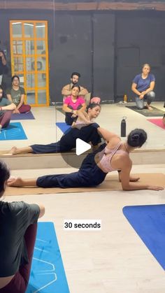 a group of people doing yoga on mats