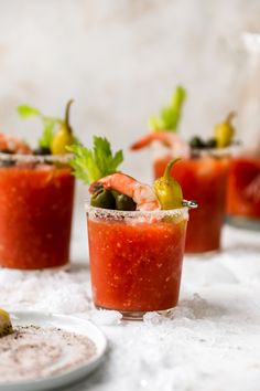 several small glasses filled with different types of food