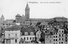 an old black and white photo of buildings with a clock tower in the back ground