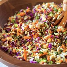 a wooden bowl filled with coleslaw and carrots