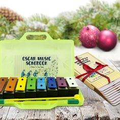 an assortment of musical instruments sitting on top of a table next to christmas ornaments and a book