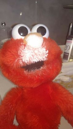 a red stuffed animal sitting on top of a table