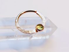 This peridot septum ring is handmade by me with gold filled hard wire and hammered for texture (gold filled wire is different than gold plated in that the plating is much thicker and the plating will never rub off. with proper care it will last as long as real gold). Soldered onto the ring is a 3mm gold filled setting with a 3mm peridot stone set inside of it. The ring is available in 16, 18, and 20 gauge and you can also choice between 10mm and 8mm for the diameter. *NOTE* To open ring twist to Rose Gold Septum Ring, Gauge Piercing, Gauge Septum, Daith Ring, Gauges Piercing, Opal Septum, Daith Rings, Daith Jewelry, Daith Piercing Jewelry