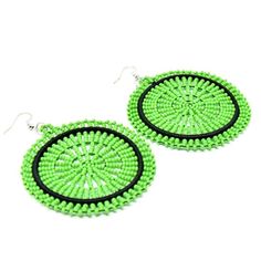 Beautiful green disc earrings made from Maasai glass beads. Handmade by women artisans in Tanzania. For set lovers, these earrings match up with most of our beaded necklaces. These classic earrings can be worn at any occasion. Earrings comes in different colors and designs. As with all handmade items, no two pieces are the same. Variations in size, color and design may occur. Dimensions: 2.5" Wide Green Earrings With Colorful Beads, Fair Trade Green Jewelry For The Beach, Green Beaded Earrings For Summer, Green Round Beaded Earrings As Gift, Green Round Beaded Earrings For Gift, Round Green Beaded Earrings As Gift, Green Beaded Earrings With Large Beads For Gift, Traditional Green Beaded Earrings With Large Beads, Handmade Green Round Earrings