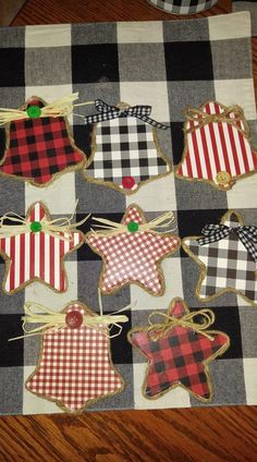 decorated cookies are sitting on a plaid tablecloth