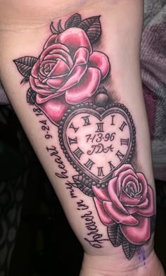 a rose and clock tattoo on the arm