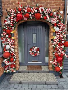 a decorated front door for christmas with candy canes and wreath